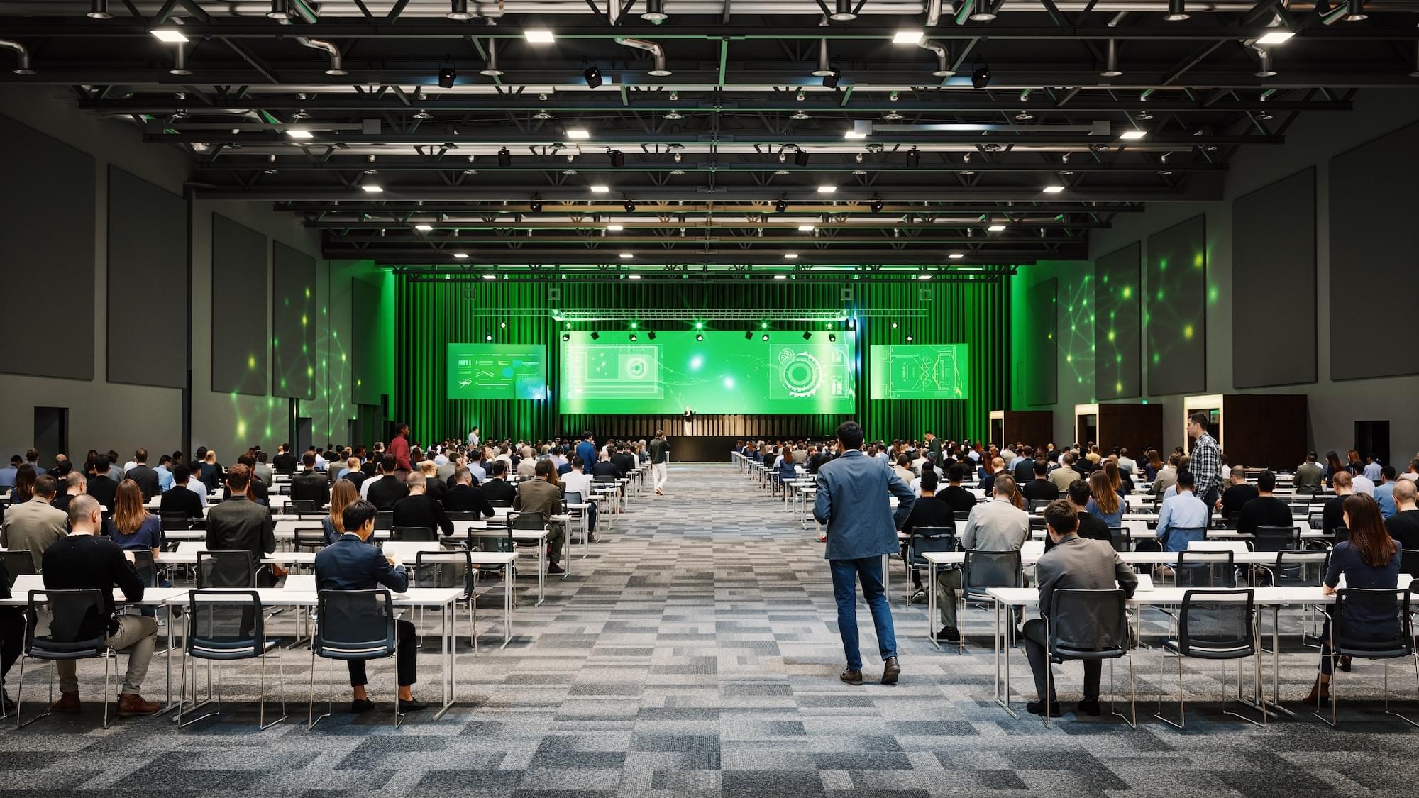 Stor konferansesal med klasseromoppsett for flere tusen mennesker.