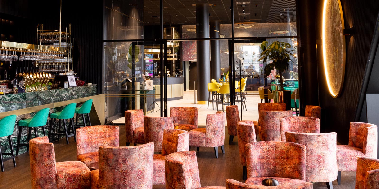Hotellets bar med lyse og fargerike stoler i moderne og stilige lokaler