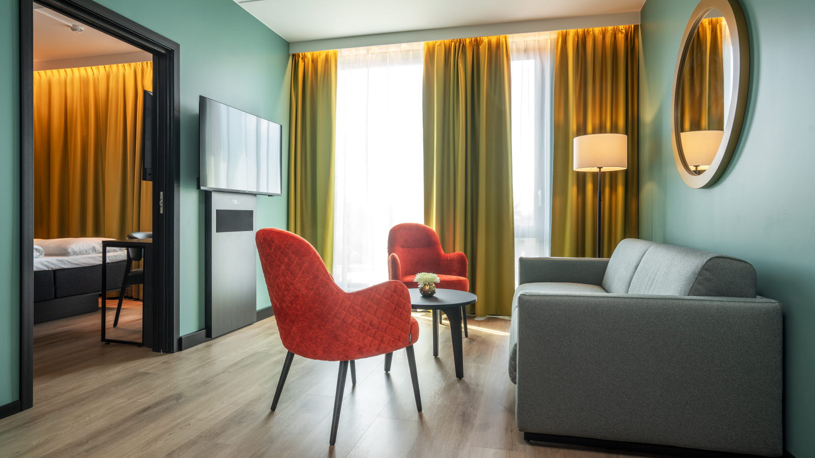 Loungegruppe foran store vinduer på et hotellrom på Thon Hotel Snø