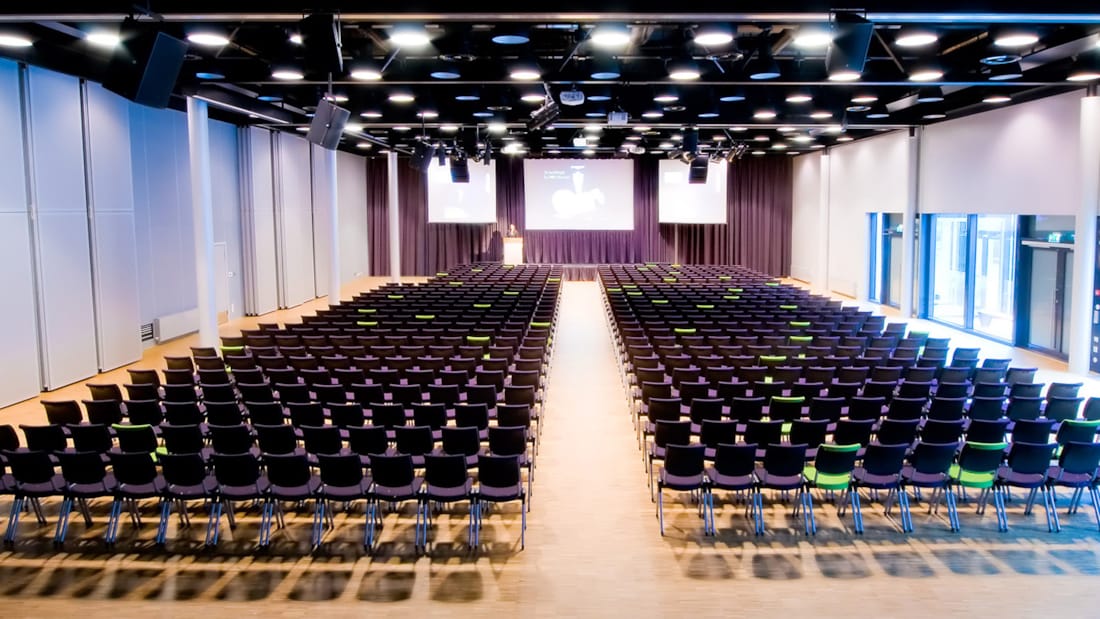 konferansesal med lerret i bakkant av bilde, stoloppsett, 450 plasser