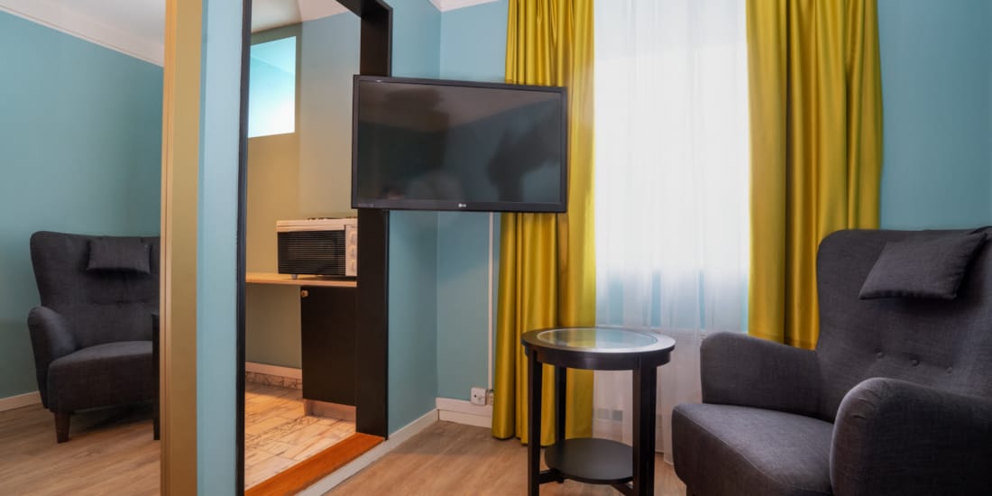 TV og sitteplass i Standard Room Single på Thon Hotel Linne Apartments