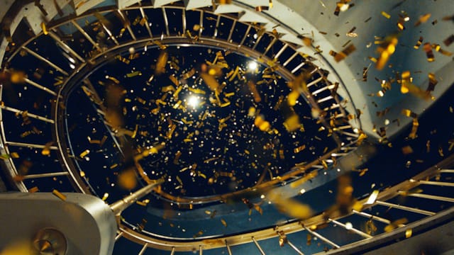 Gullkonfetti som daler ned fra en vindeltrapp