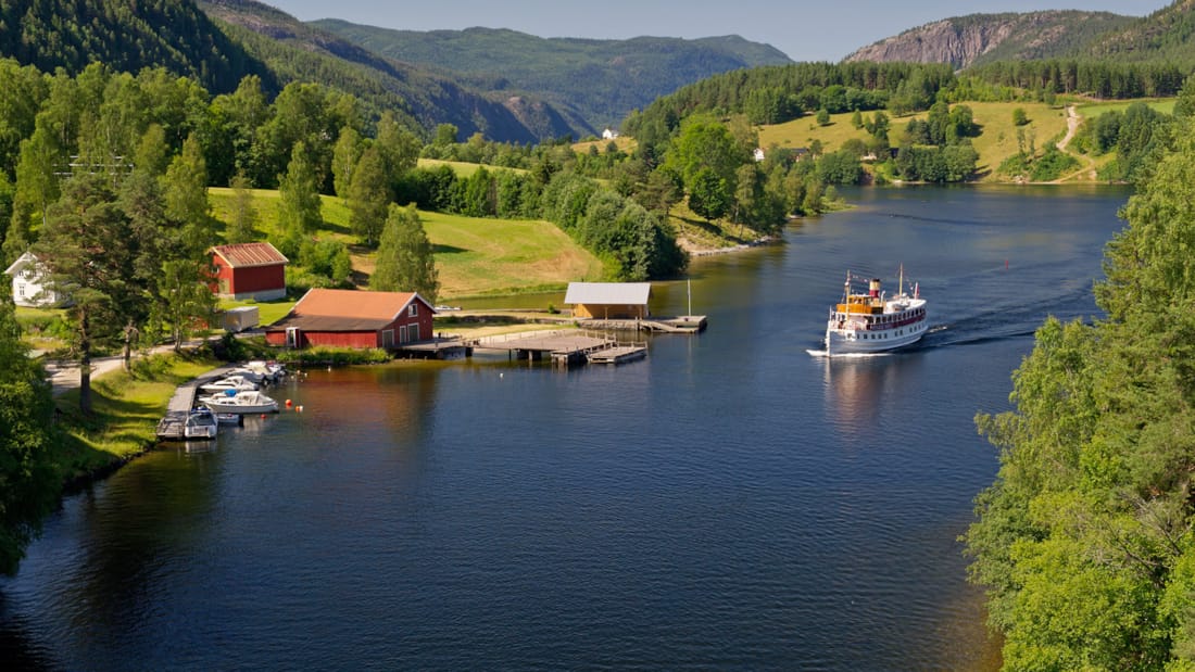 Båt som kjører nedover Telemarkskanalen om sommeren